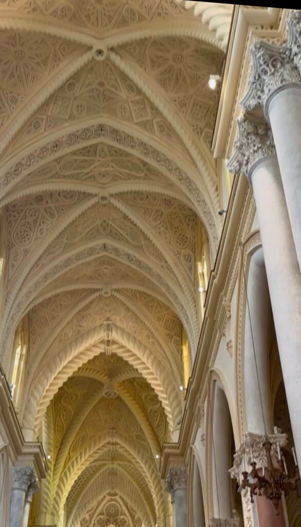 Intricate vaulted nave inside a historic church in Erice, Sicily.
