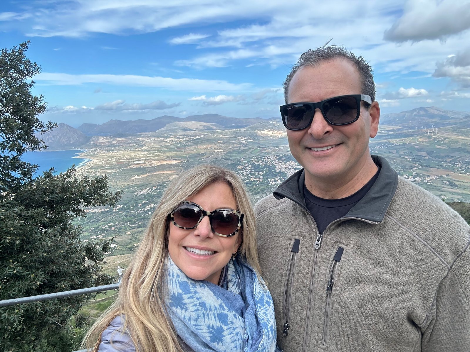 Travelers enjoying panormic views from Erice, a medieval hilltop town in Sicily, Italy.