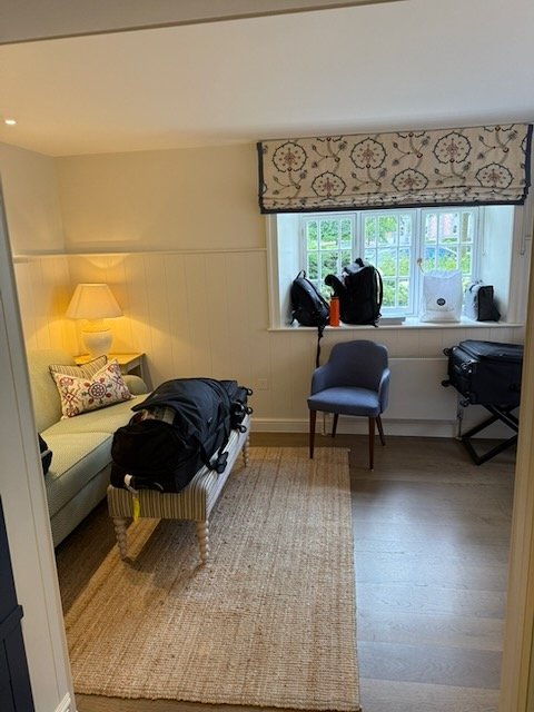 Packed luggage and travel bags in a hotel room in Ireland.