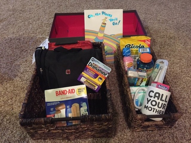 Travel first-aid kit and travel essentials organized in baskets before a trip,
